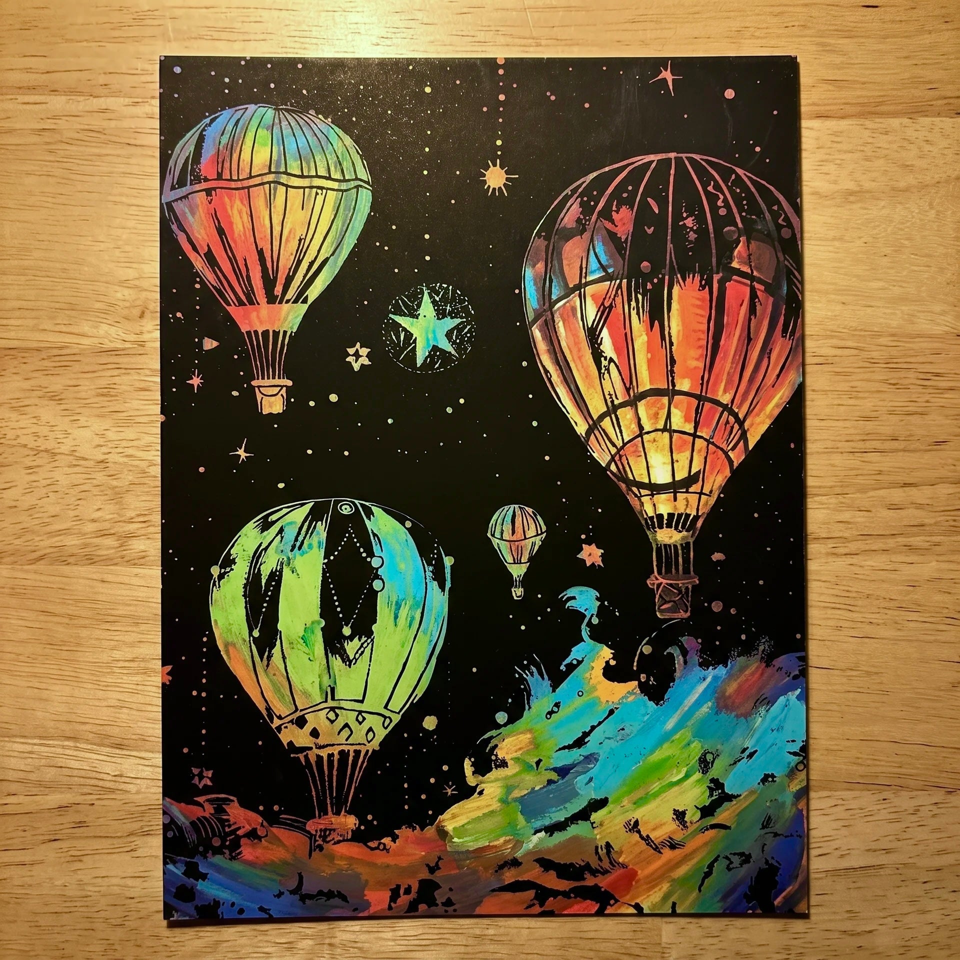 Completed A4 Glowing ScratchBoard with four hot air balloons and a starry night sky